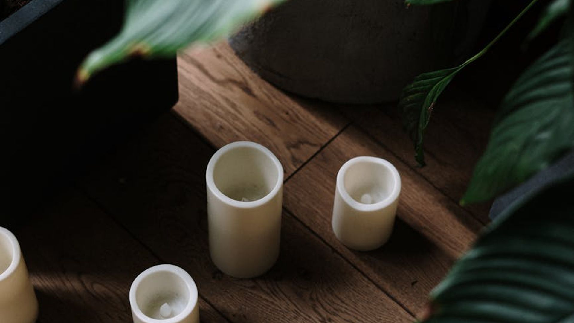 Serene yoga atmosphere with soft lighting in dark studio.