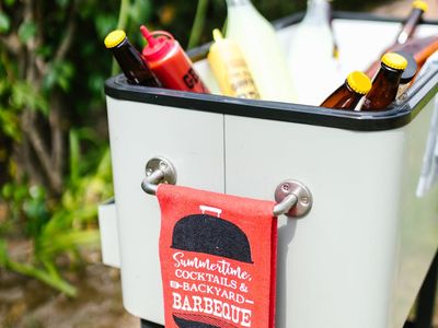 Water bottle and towel on dark floor.